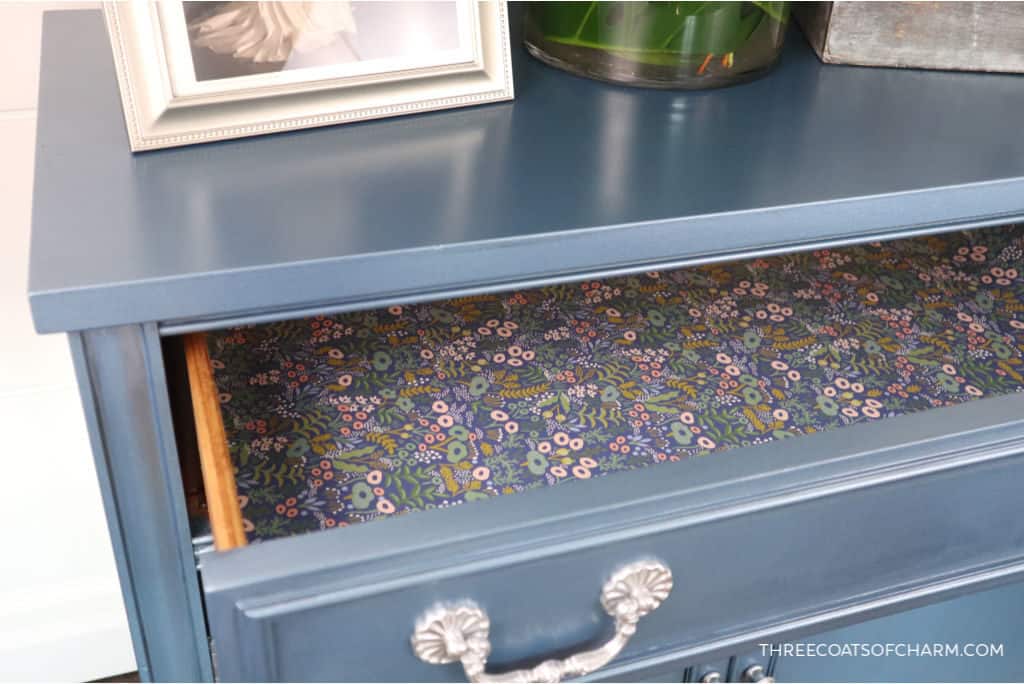 Metallic blue painted cabinet with floral paper draw liner