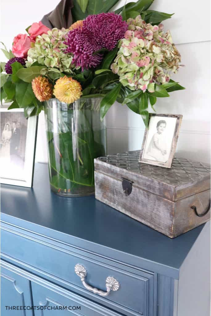 Metallic blue painted cabinet with flowers