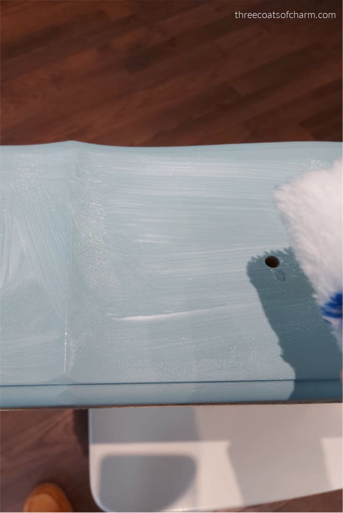 Applying Mod Podge to furniture for decoupage